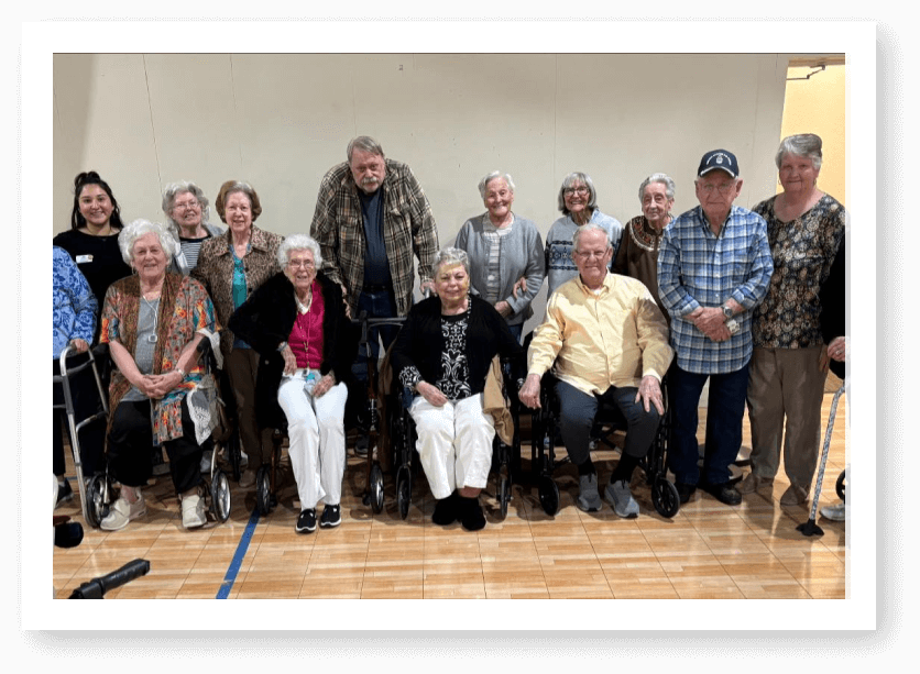 Group Of Elderly Residents Posing Together During Gathering at Assisted Living Facility