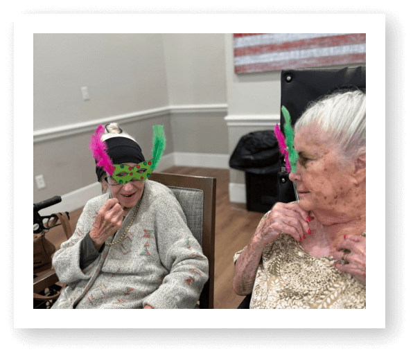 Elderly Women Wearing Festive Masks During Celebration at Memory Care Facility