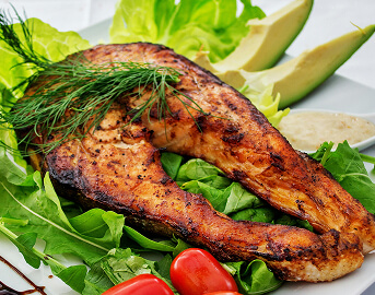 Grilled Salmon Steak Served with Fresh Greens and Vegetables at Memory Care Facility Grilled Salmon Steak Served with Fresh Greens and Vegetables at Memory Care Facility
