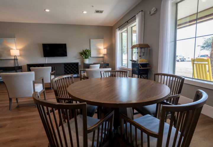 Common Area Lounge with Round Table and TV for Seniors at Assisted Living Facility Common Area Lounge with Round Table and TV for Seniors at Assisted Living Facility