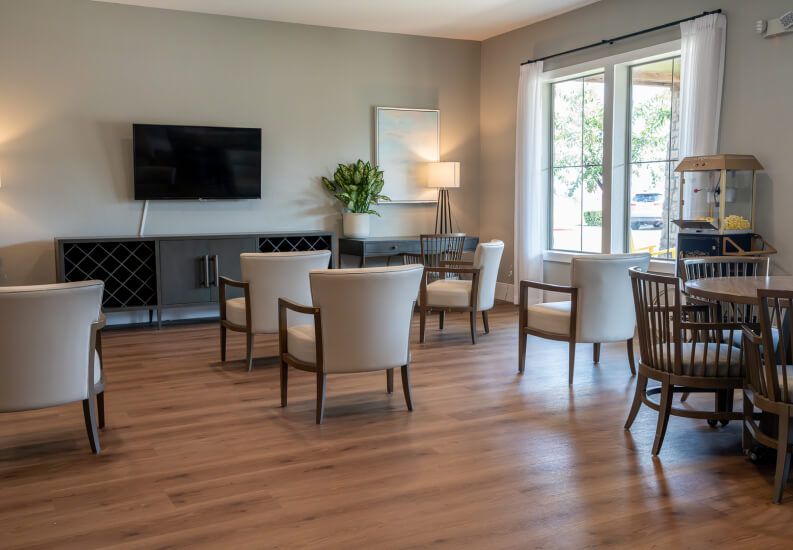 Bright Lounge with TV and Mixed Seating for Seniors at Assisted Living Facility Bright Lounge with TV and Mixed Seating for Seniors at Assisted Living Facility