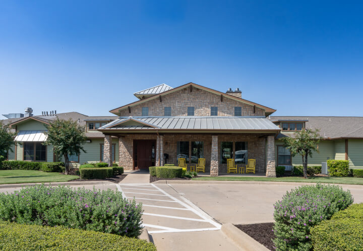 Stone Facade Front Entrance with Covered Porch for Seniors at Assisted Living Facility Stone Facade Front Entrance with Covered Porch for Seniors at Assisted Living Facility