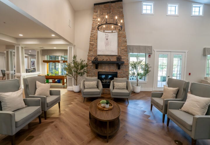 Grand Lounge with Stone Fireplace and Vaulted Ceiling for Seniors at Assisted Living Facility Grand Lounge with Stone Fireplace and Vaulted Ceiling for Seniors at Assisted Living Facility