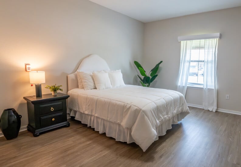 Private Resident Bedroom with King Bed and Natural Light for Seniors at Assisted Living Facility