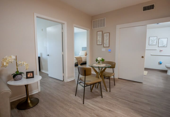 Resident Suite Living Area with Bedroom View for Seniors at Assisted Living Facility