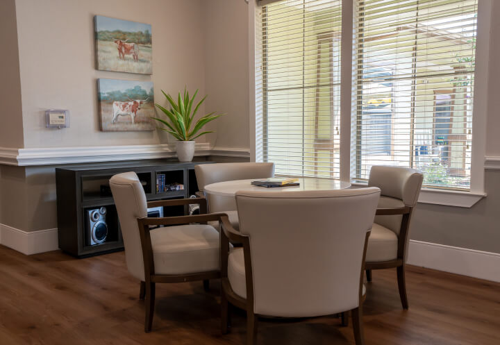 Sitting Room with Round Table and Western Art for Seniors at Memory Care Facility Sitting Room with Round Table and Western Art for Seniors at Memory Care Facility