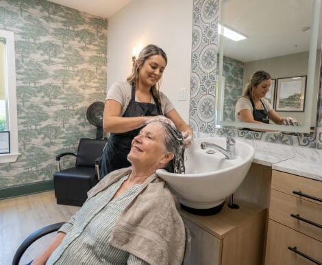 Senior Woman Getting Hair Washed in Onsite Salon at Assisted Living Facility Senior Woman Getting Hair Washed in Onsite Salon at Assisted Living Facility