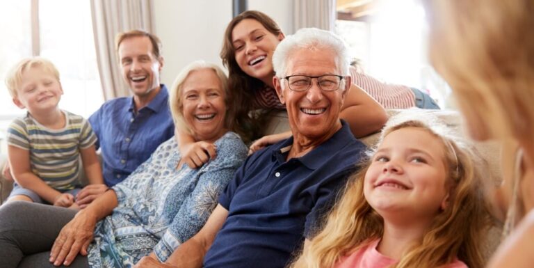 Multi-Generational Family Laughing Together at Memory Care Facility