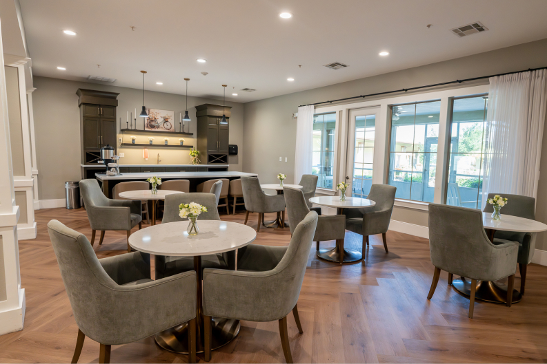 Bistro Cafe with Marble Tables and Bar Seating for Seniors at Assisted Living Facility Bistro Cafe with Marble Tables and Bar Seating for Seniors at Assisted Living Facility