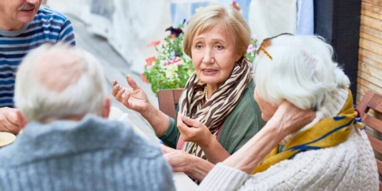 Elderly Residents Sharing Conversation Outdoors at Assisted Living Facility